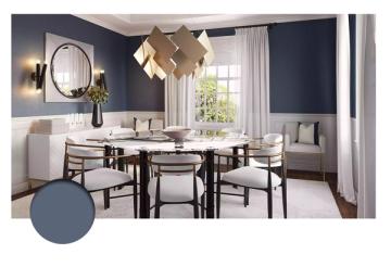 Modern dining room in deep navy with geometric pendant light, neutral upholstered chairs, and bright natural light emphasizing clean elegance