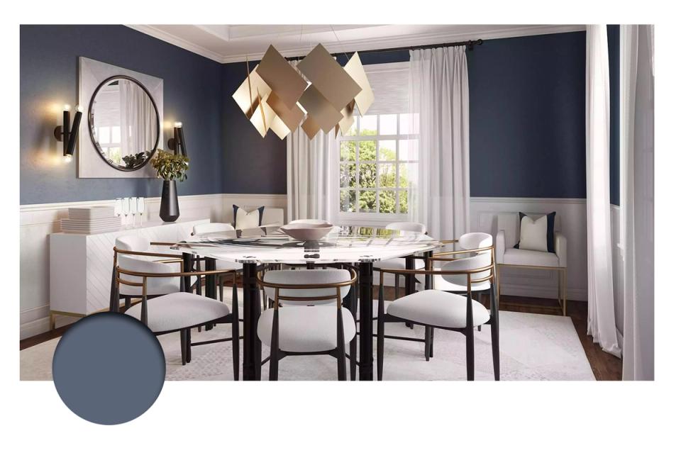Modern dining room in deep navy with geometric pendant light, neutral upholstered chairs, and bright natural light emphasizing clean elegance
