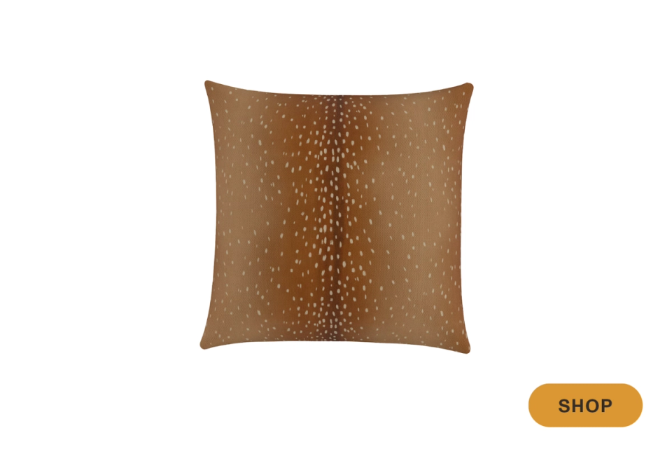 Rust-toned square pillow with subtle dotted texture pattern, warm earthy contemporary style