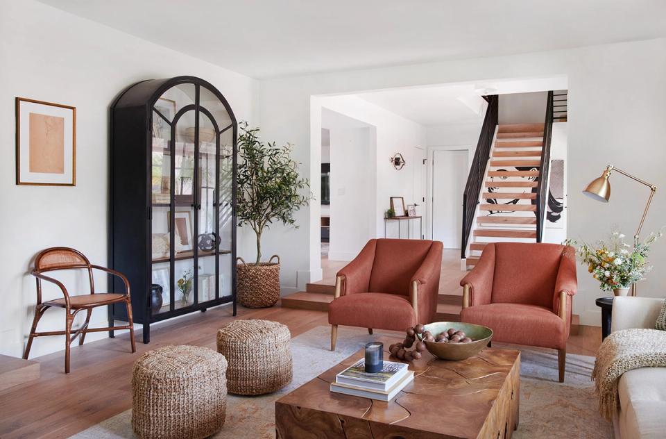 Mid-century modern living space with terracotta accents, arched doorway, and natural wood tones