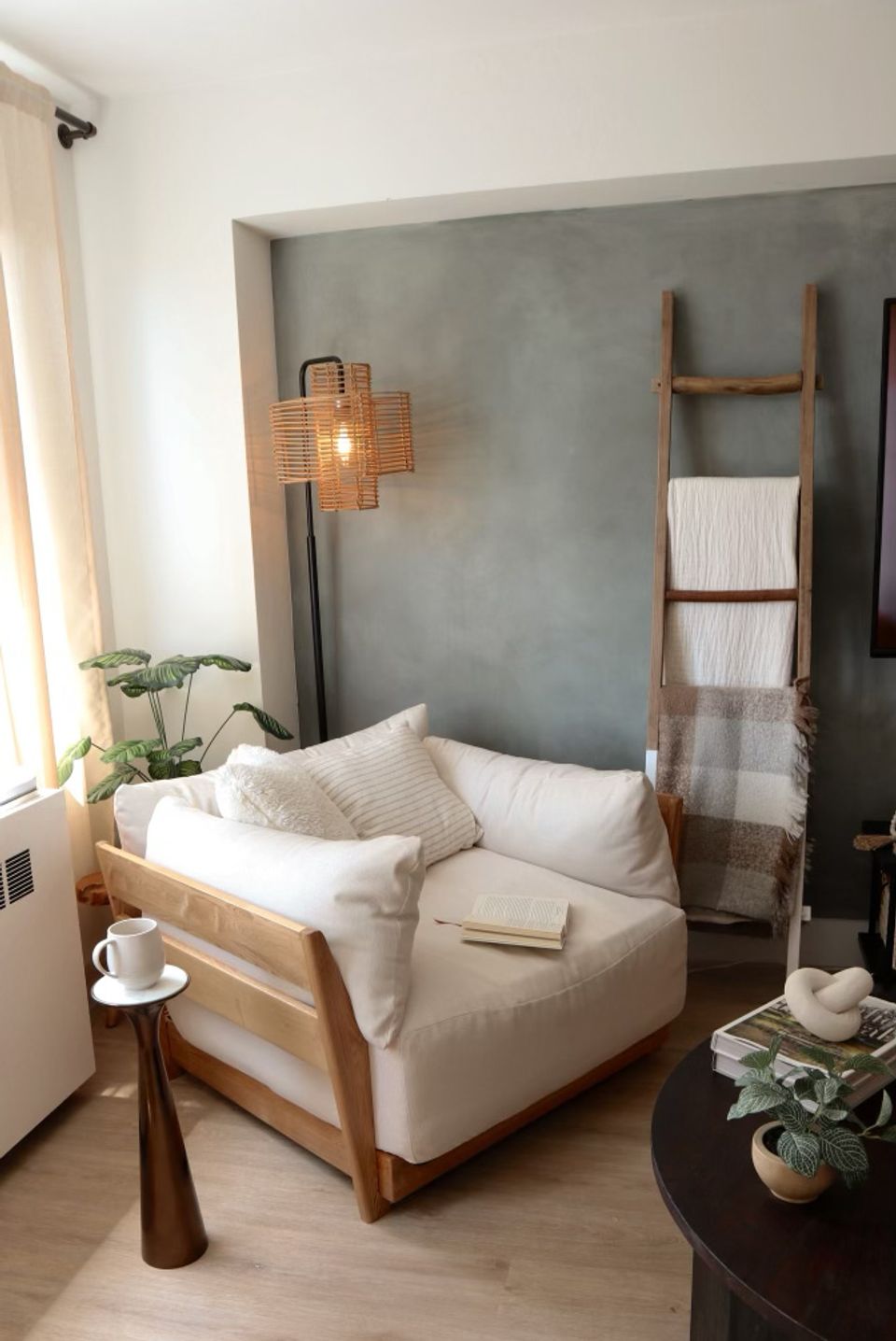 Mid-century modern bedroom featuring textured green limewash wall, natural wood bed, and copper lighting.