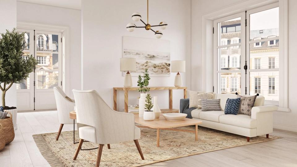 Bright Scandinavian living room with warm white walls, natural wood furniture, and neutral textiles creating a calm, airy atmosphere.