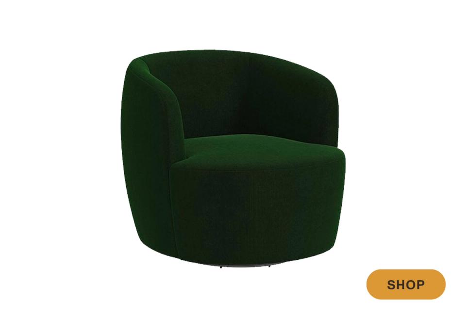 Luxe rounded swivel chair in deep forest green velvet