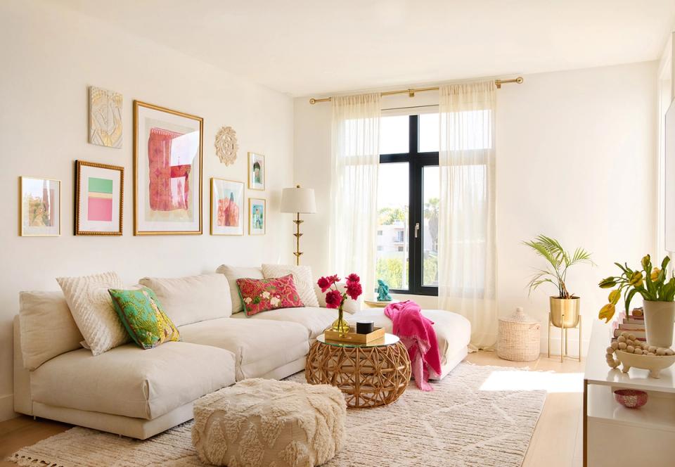 Bright Scandinavian space with cream modular sofa, gallery wall, and colorful accent pieces