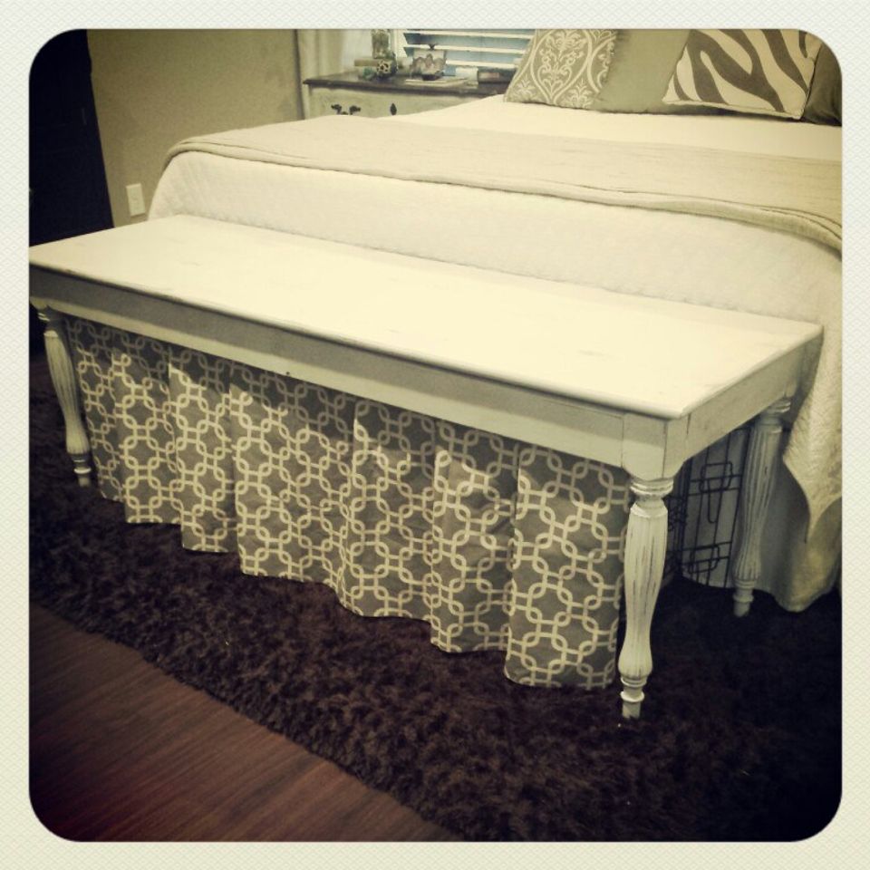 Pet crate hidden under bed with geometric patterned dust skirt concealment