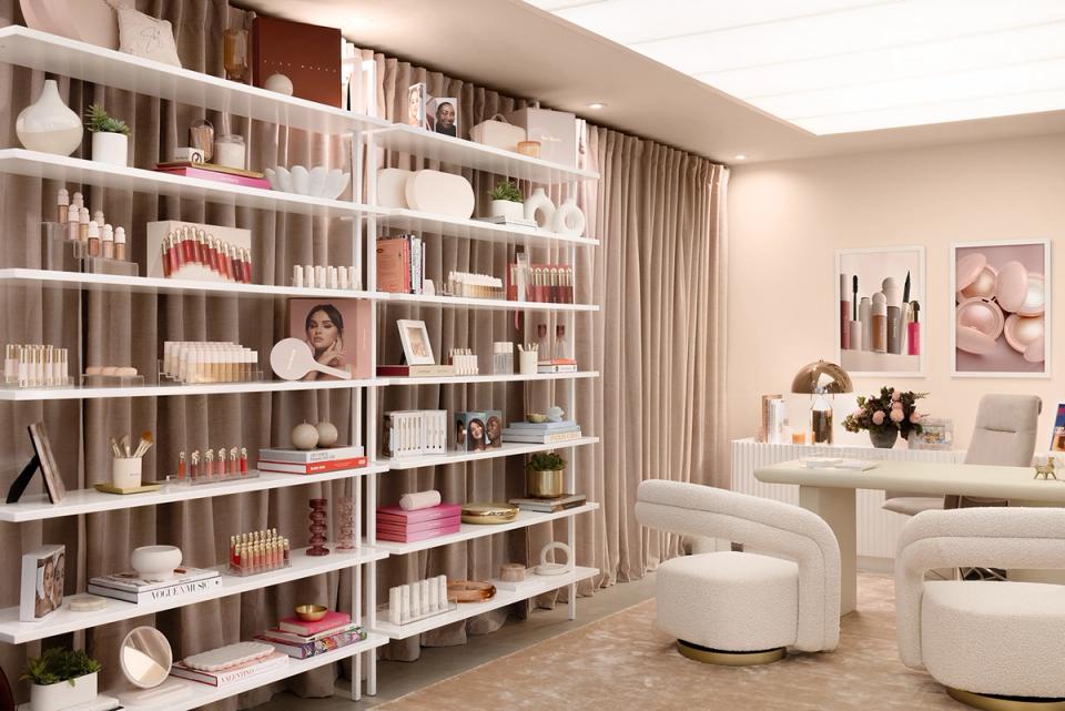 Refined retail space with organized shelving, cream furnishings, and soft neutral color scheme