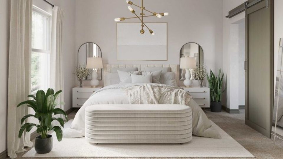 Serene minimalist bedroom with curved white linen headboard, potted plants, and calming neutrals