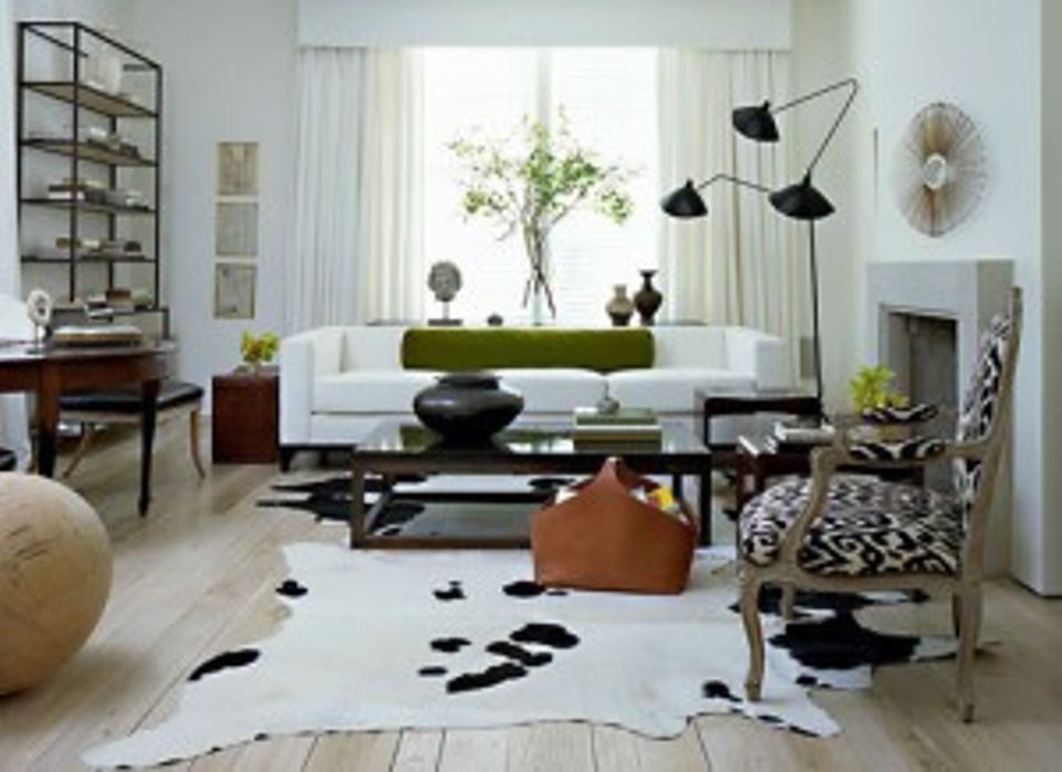 Mid-century modern lounge with crisp white sofa, geometric black accents, natural light, and organic textures.