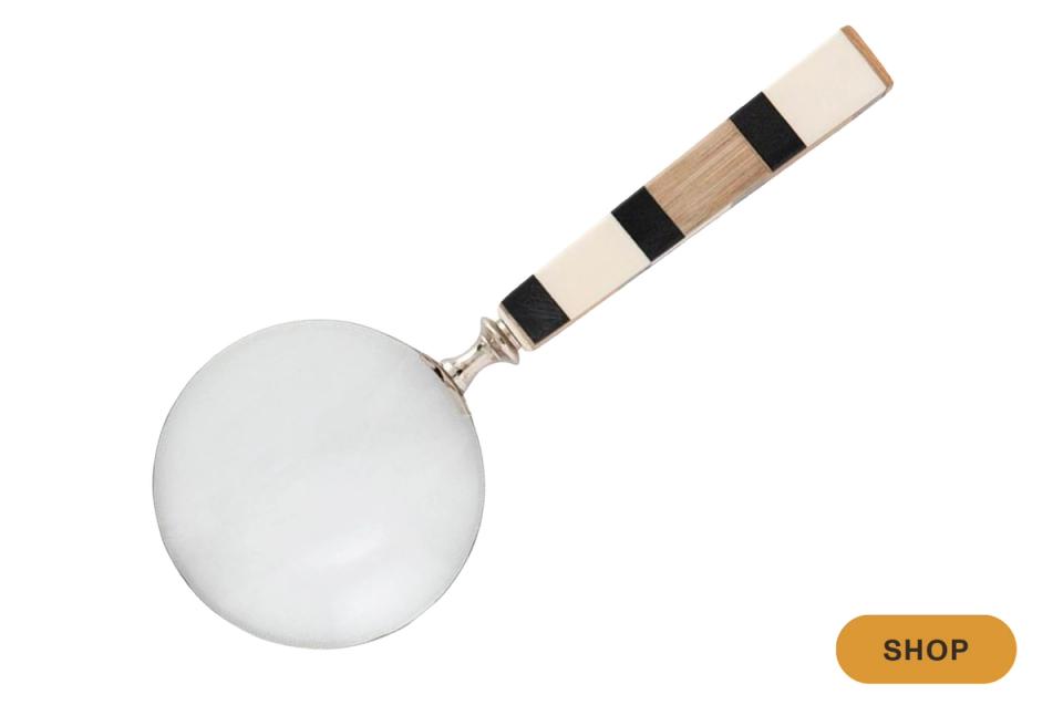 Minimalist magnifying glass with striped wood and metal handle in neutral tones