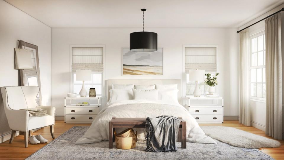 Serene bedroom with warm white walls, white furnishings, natural wood floors, and soft textures creating a peaceful, restful retreat.