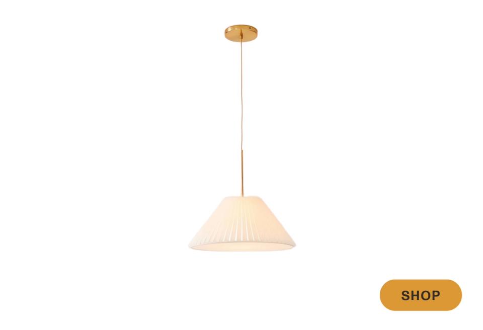 Minimalist cream pleated pendant with brass fixture, soft diffused light