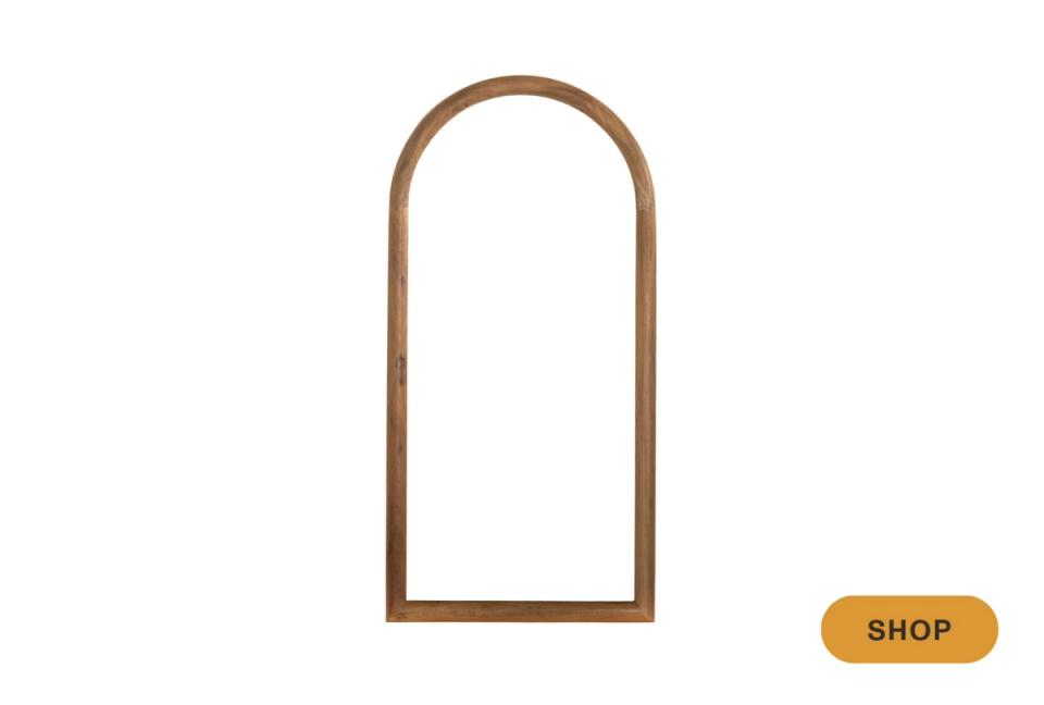 Arched wooden mirror with warm walnut finish