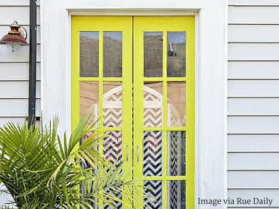 Coastal modern entryway with lime-green neon doors and chevron pattern