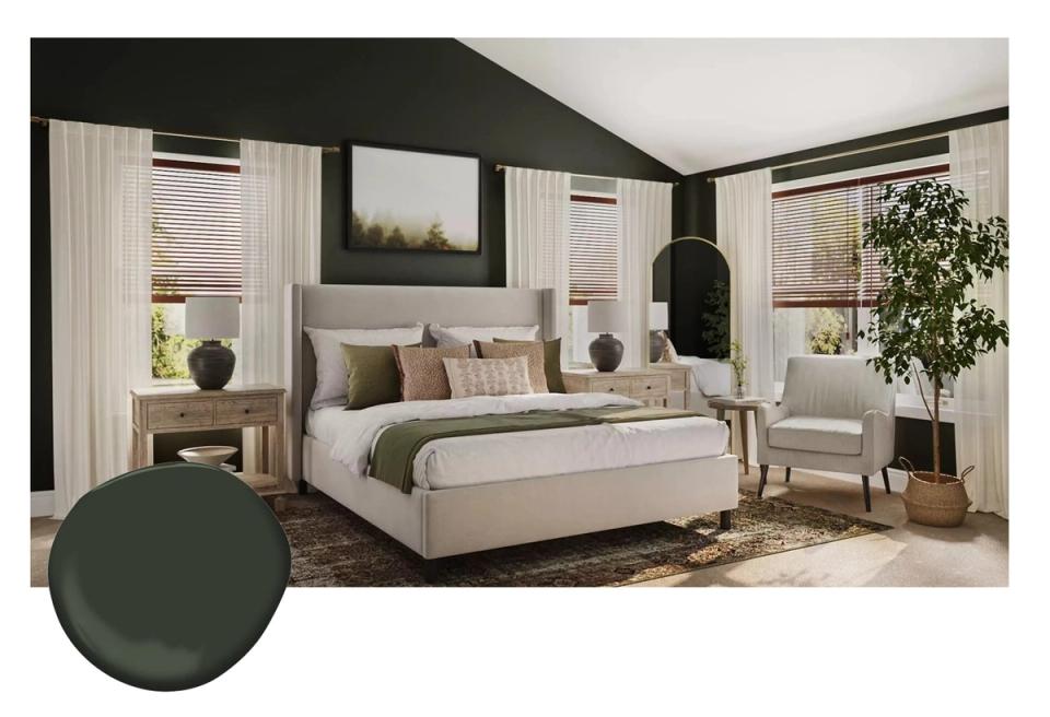 Sophisticated bedroom with dark green accent wall, neutral upholstered bed, and warm layered lighting creating a serene, moody retreat.