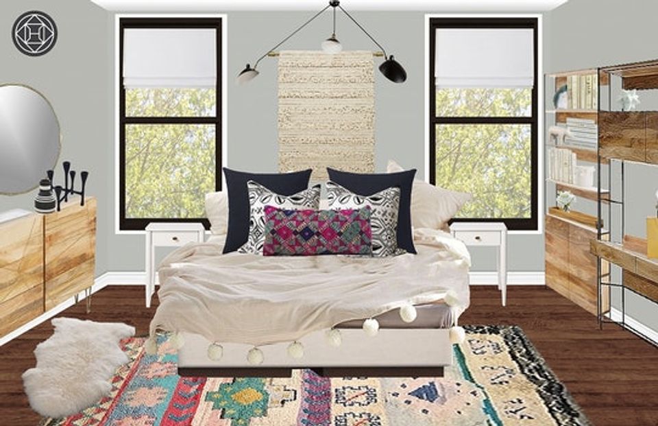 Boho bedroom blending natural wood furniture, jewel-tone patterned rug, cream bedding, and abundant natural light