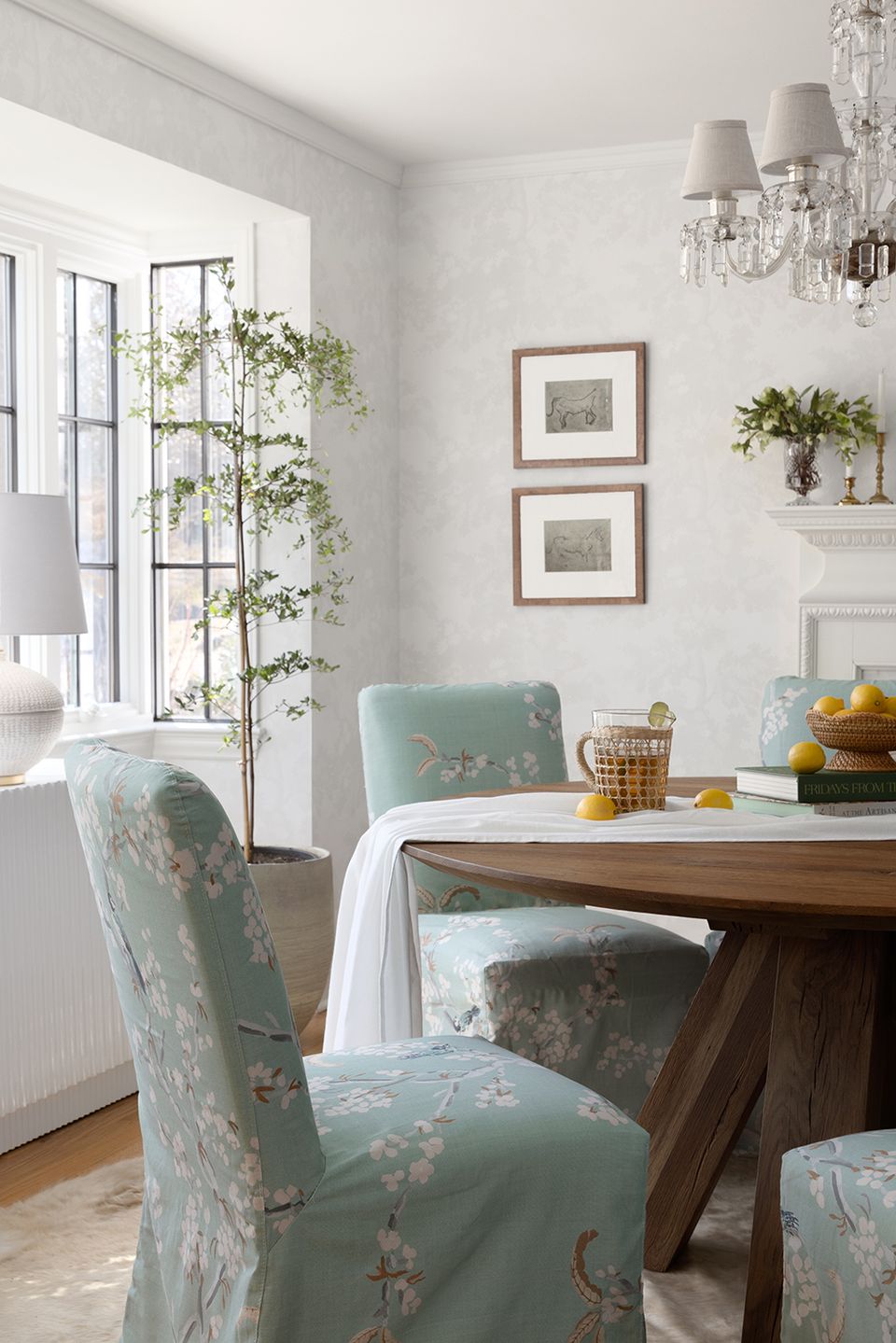 Farmhouse dining room with floral upholstered chairs, wood table, and botanical accent colors