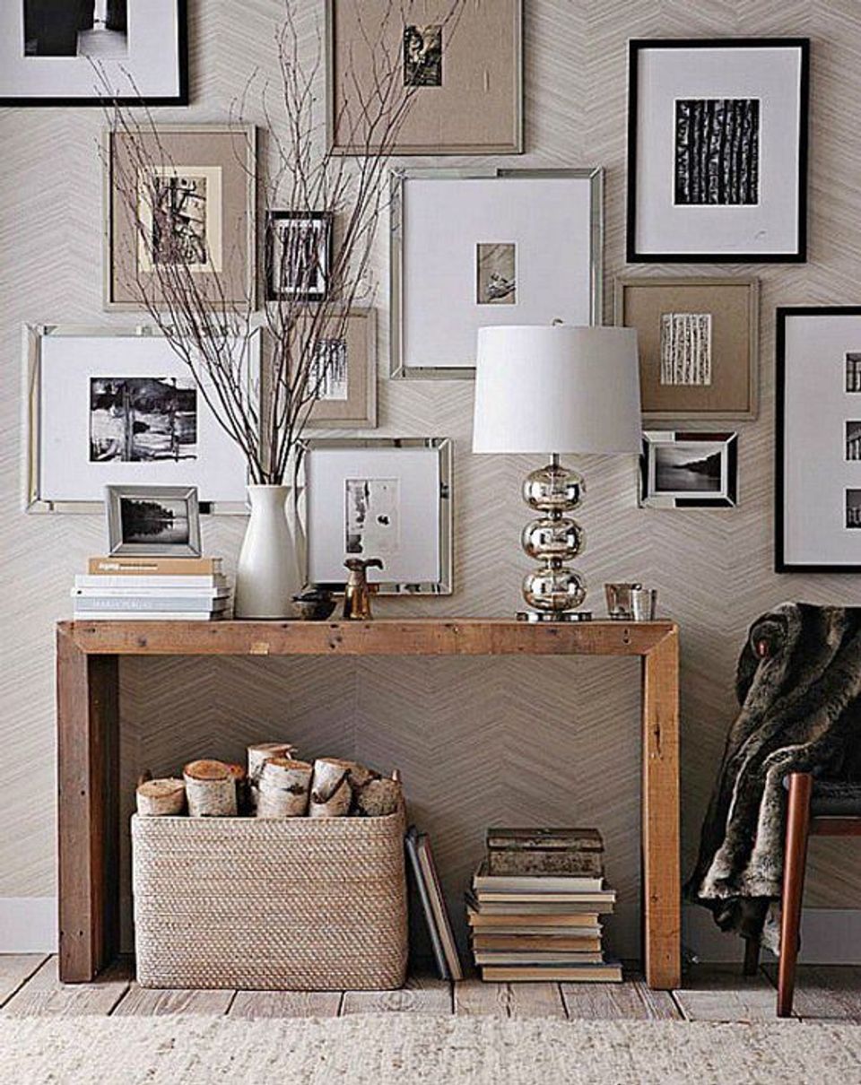 Contemporary eclectic entryway with mixed-frame gallery wall, wood console, dried florals, and neutral textured backdrop