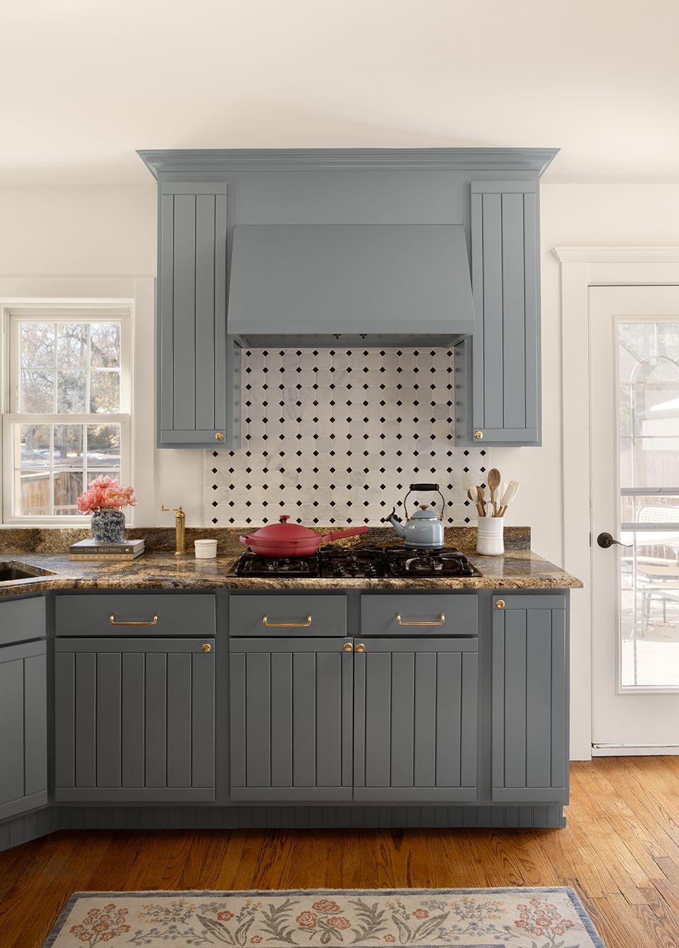Soft gray farmhouse kitchen with beadboard cabinetry, white pegboard backsplash, and warm wood accents