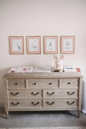 Soft, feminine dresser with framed botanical prints, pale wood finish, delicate styling