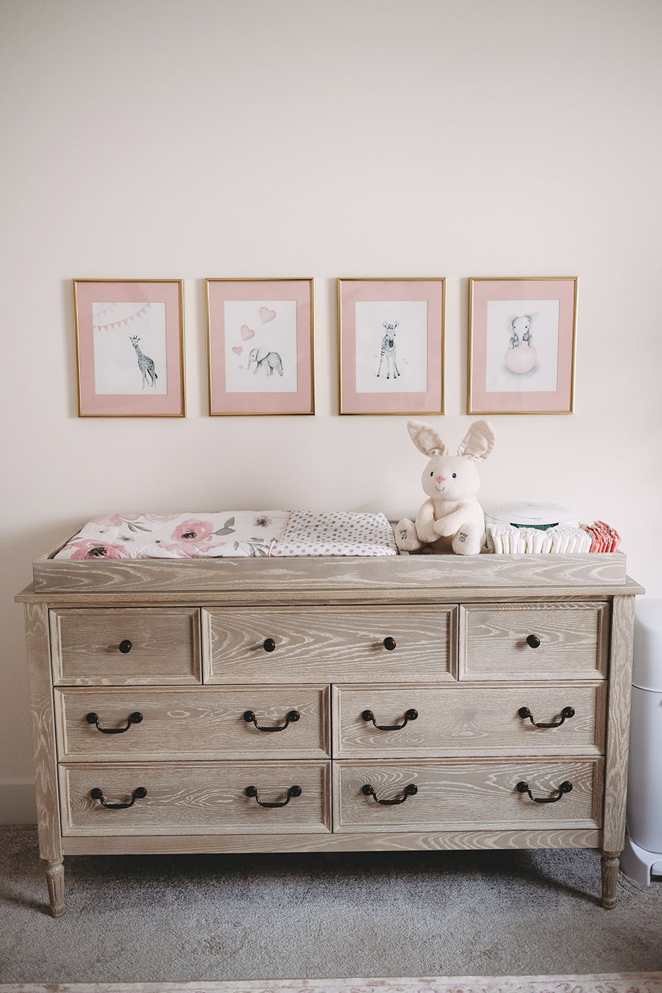 Soft, feminine dresser with framed botanical prints, pale wood finish, delicate styling