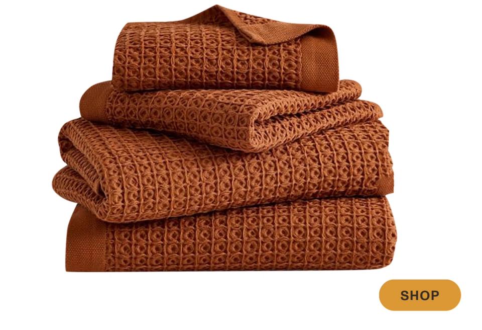 Rust-brown towels with quilted diamond pattern, warm earthy spa-like aesthetic