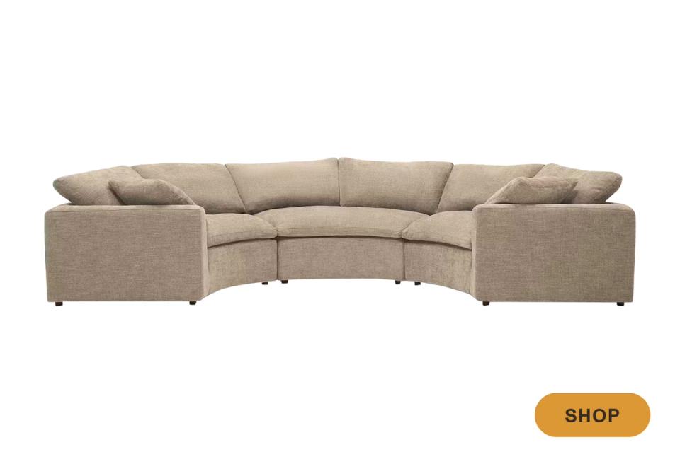 Curved beige sectional sofa with rounded silhouette and contemporary neutral aesthetic