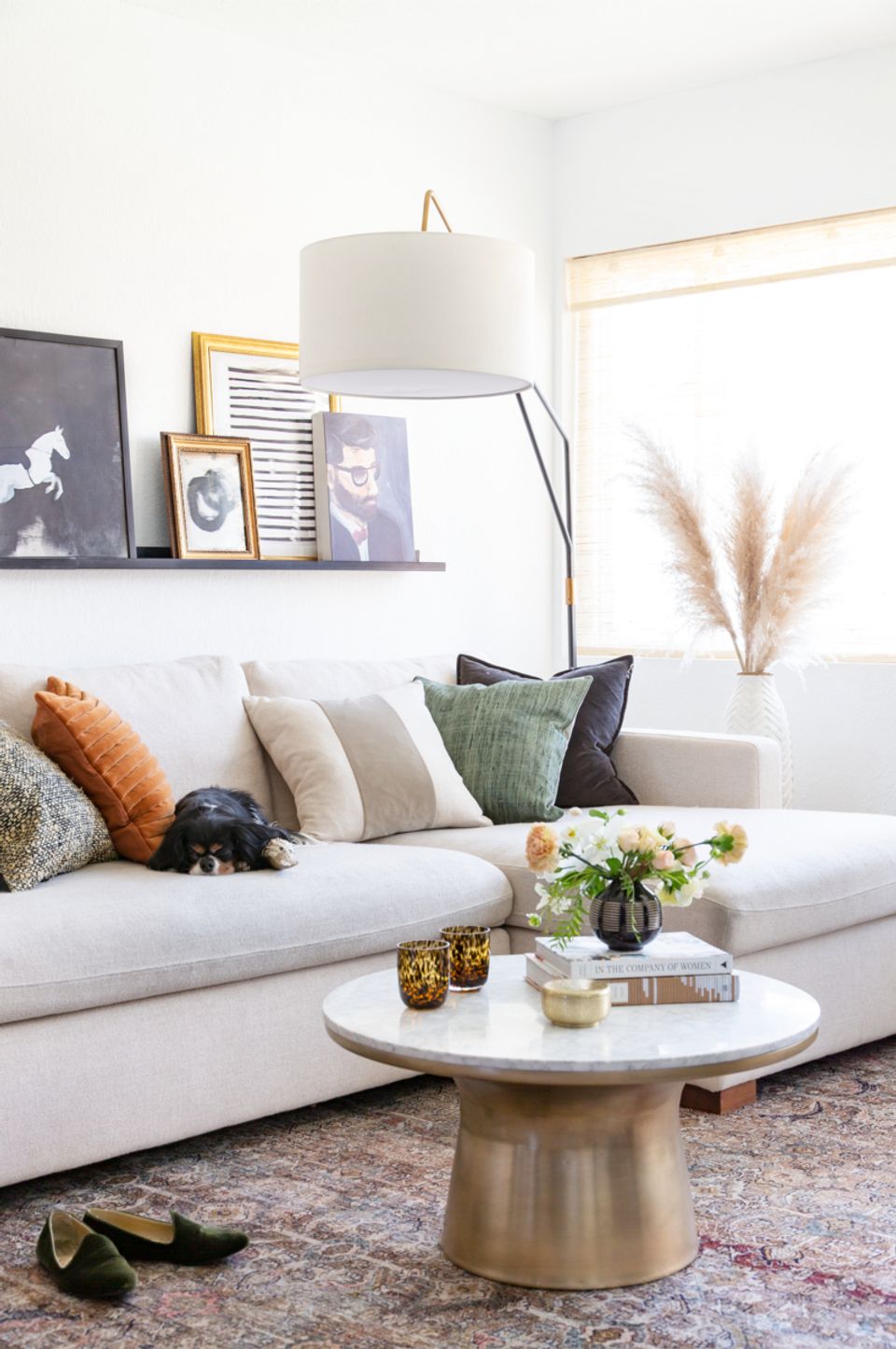 Eclectic modern space with arched floor lamp and layered textural styling