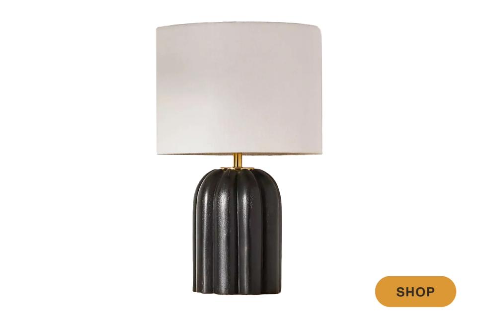 Industrial-chic table lamp with fluted black ceramic base and soft linen shade