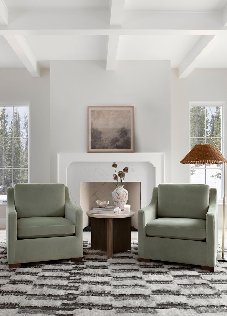 Transitional living room featuring muted sage green armchairs, white architectural details, and neutral palette emphasizing timeless, understated sophistication.