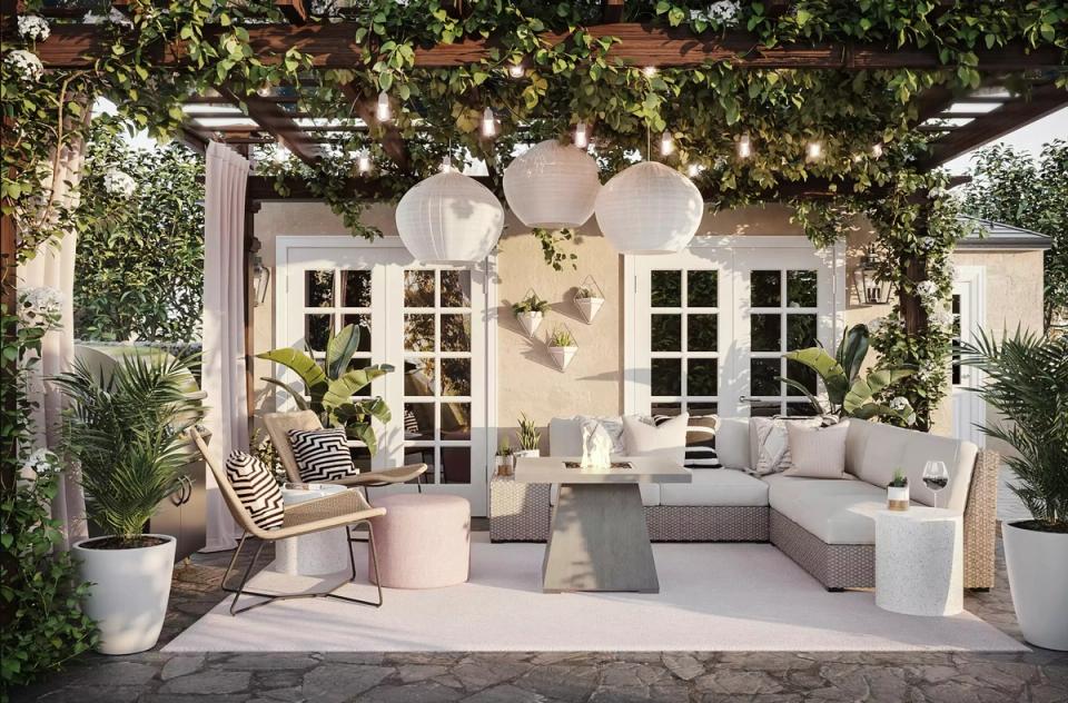 Mediterranean-style garden room with arched doorways, soft neutral furnishings, and abundant climbing ivy and plants.