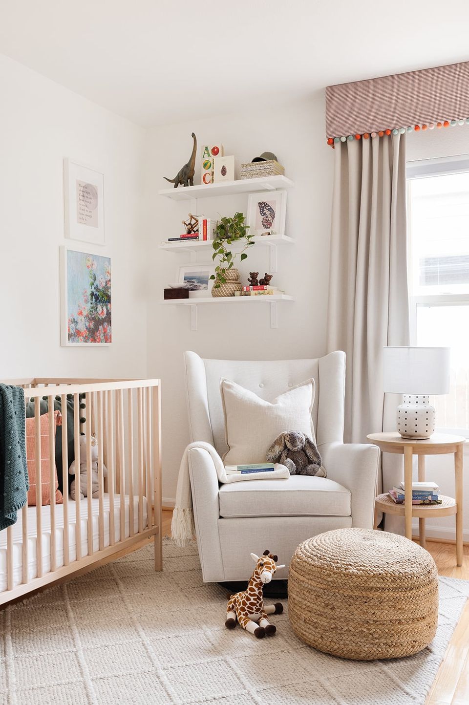 Scandinavian nursery in warm neutrals with floating shelves, cream furnishings, and natural textures
