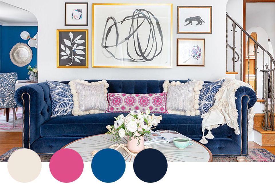 Bold eclectic space featuring deep navy sofa with vibrant pink and gold gallery wall, playful maximalist mood