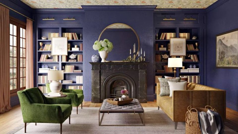 Moody library-inspired living room with deep navy walls, round gold mirror above fireplace, emerald velvet chair, and rich wood shelving
