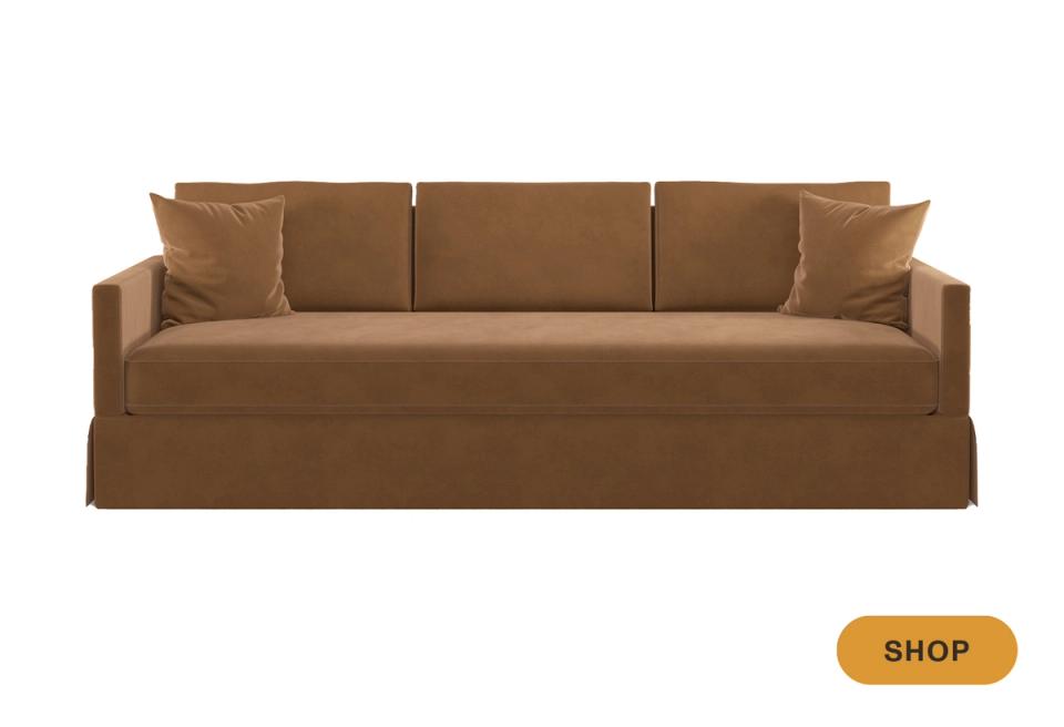 Classic camel sofa with skirted base, tailored silhouette, and sophisticated neutral aesthetic