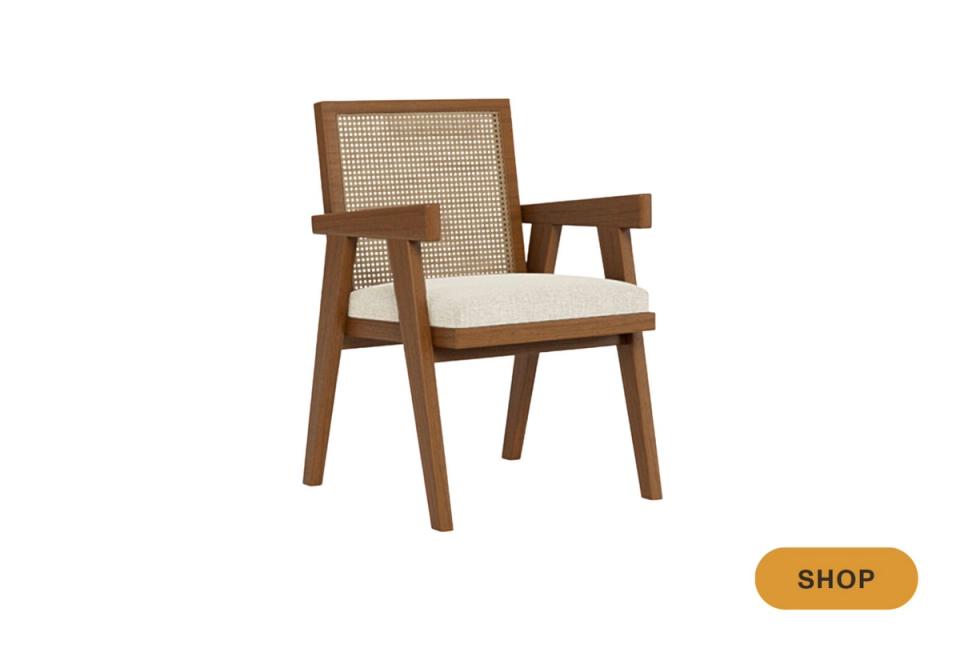 Mid-century modern wood chair with woven cane back and cream upholstered seat