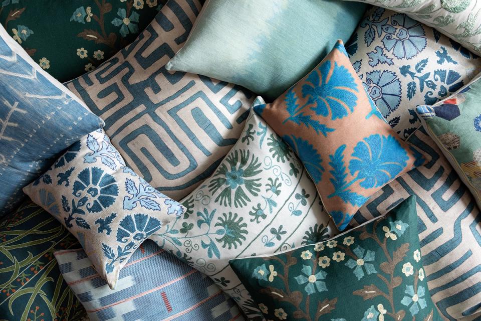 Curated collection of patterned throw pillows in jewel tones with geometric and botanical motifs