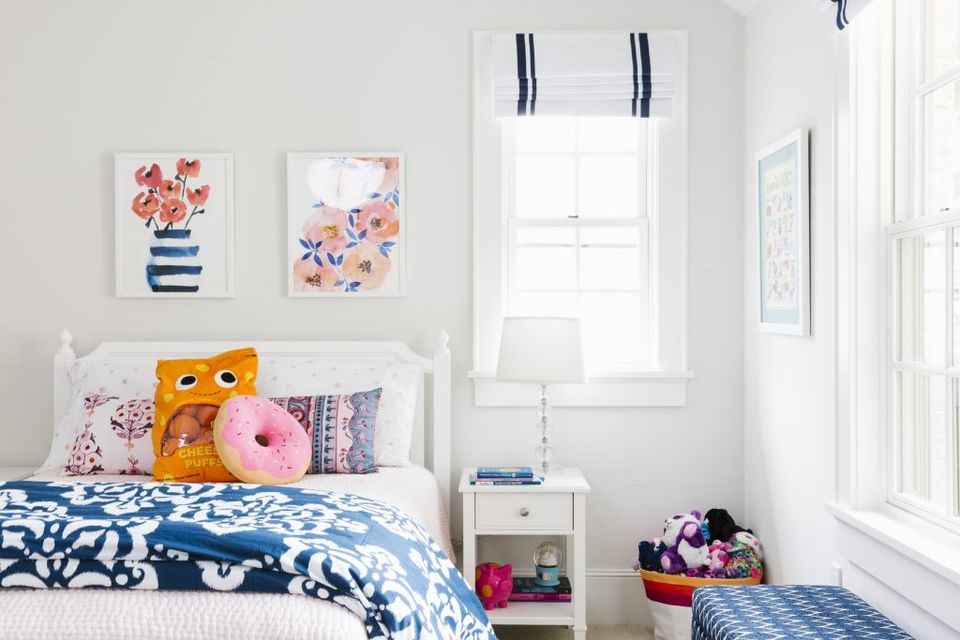 Cheerful kids' bedroom blending nautical and floral patterns with navy, pink, and white tones in a playful, curated design.