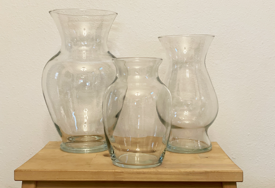 Neutral glass vases on wooden surface showcase minimalist, organic home styling approach