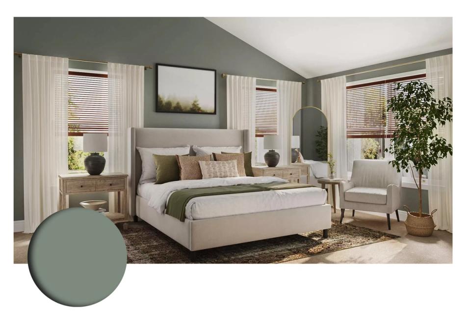 Modern bedroom blending muted green sloped ceiling, cream upholstered bed, and warm wood accents for sophisticated, restful atmosphere