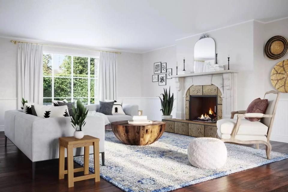 Bright transitional living room with cream fireplace, arched mirror, natural light, warm wood tones, and soft neutral palette