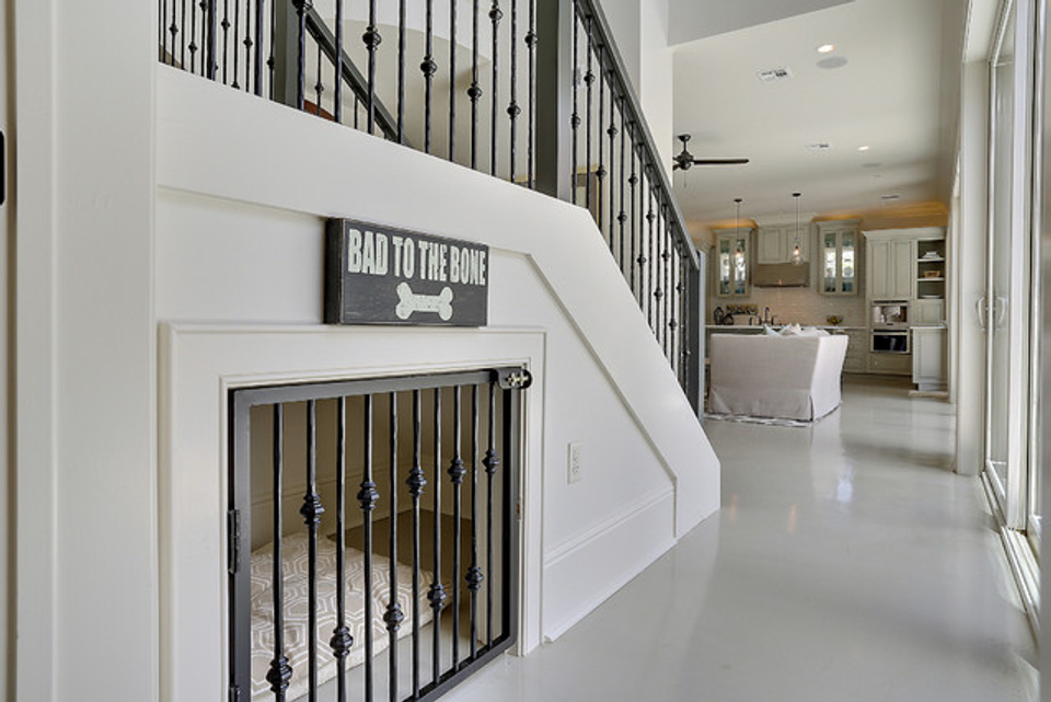 Modern white staircase with integrated black metal pet gate seamlessly built-in
