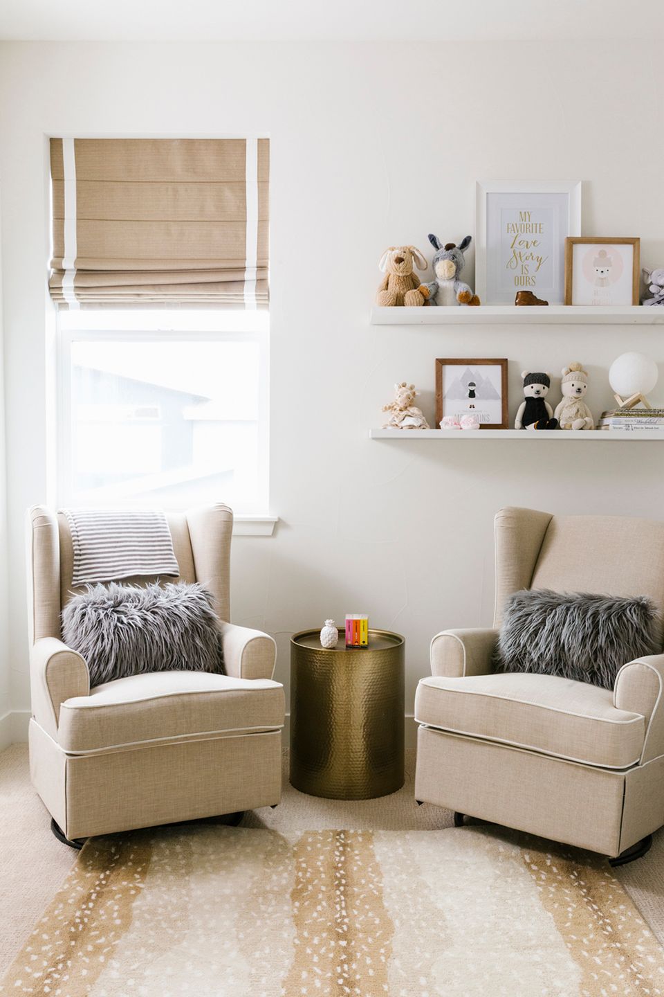 Serene neutral reading corner with cream chairs, brass accents, and soft textures for cozy story time