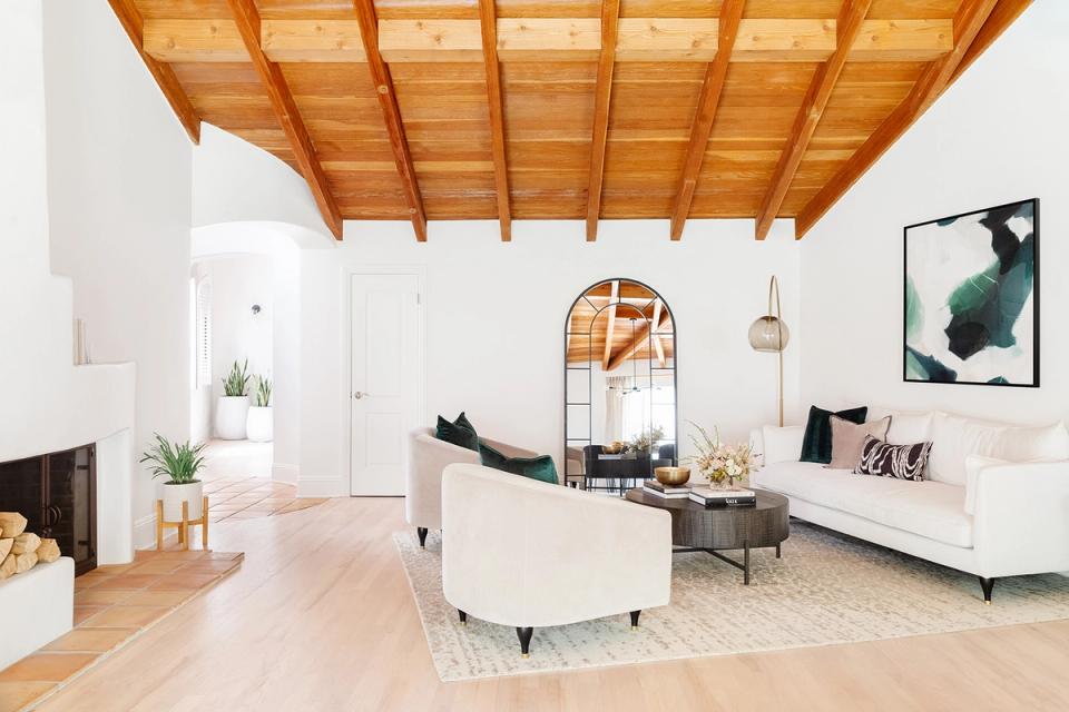 Scandinavian loft with exposed wood ceiling, white walls, and minimal furniture in warm tones