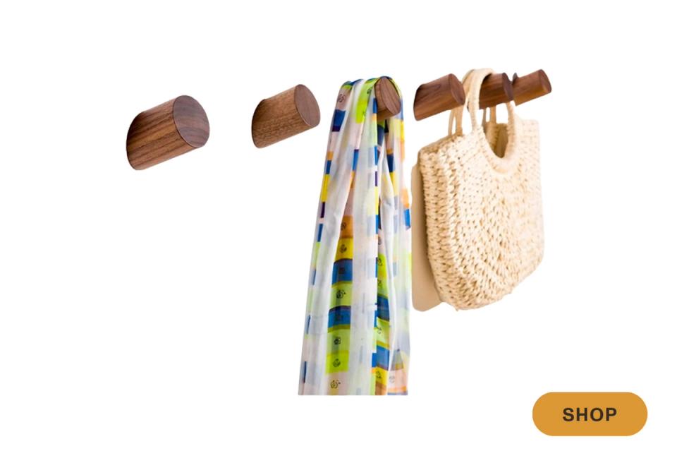 Scandinavian wooden wall hooks with patterned fabric and woven basket storage