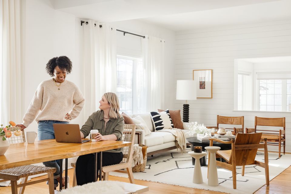 Bright Scandinavian workspace blending natural wood furniture, neutral tones, and minimalist decor with warm sunlight