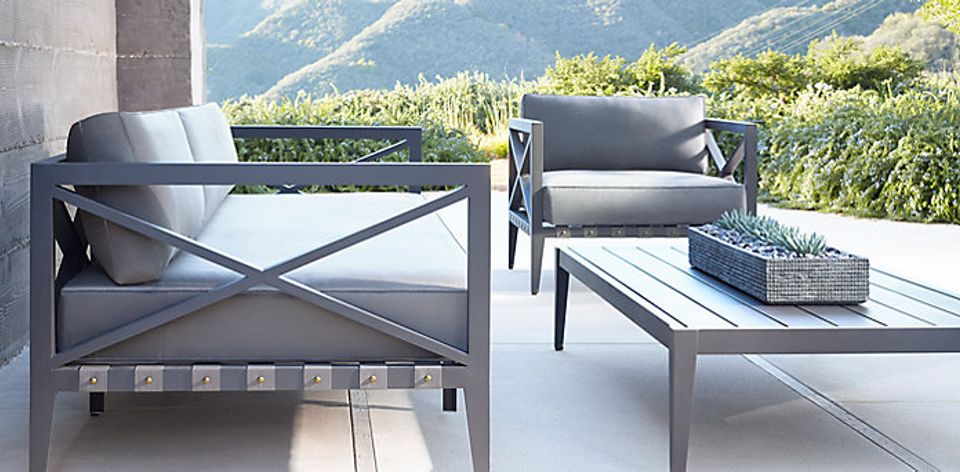Contemporary mountain lounge, gray metal seating, alpine landscape backdrop