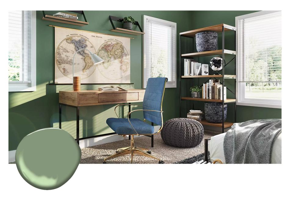 Refined home office with deep forest green walls, vintage wood desk, blue chair, and curated shelving evoking scholarly elegance