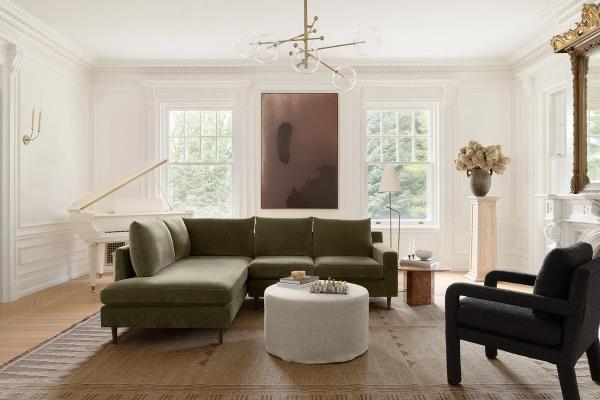 Light-filled living room with wainscoting trim, olive green sectional, picture windows, and timeless neutral palette