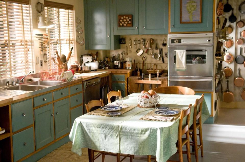 Vintage green kitchen with character details, warm lighting, and nostalgic countryside aesthetic