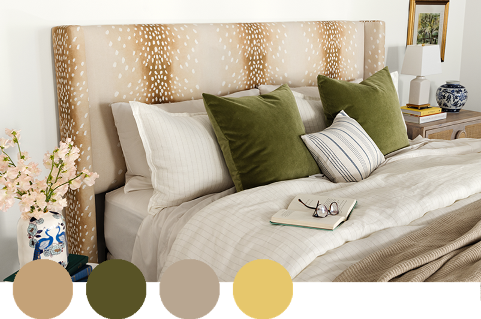 Cozy bedroom with sage green pillows, warm ochre headboard, and soft neutral bedding